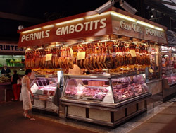 Legs of ham, hung like in this market in Barcelona, also hung in most cafes!