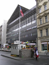 The infamous CheckPoint Charlie. Once the only place you 
                      could cross though the dead zone between East and West Germany 
                      it now plays host to university students dressed in miliary 
                      uniforms who have their photos taken with tourists.