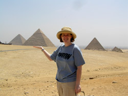 Walk like an Egyptian! Kate does her best to support the Khefre pyramid as it rests on the Giza plateau, its fellow pyramids surrounding it.