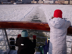 We took a boat out into the harbour, and these kids are transfixed by the way the floating ice seems to merge back in our wake, removing evidence that anything dared to pass through it.