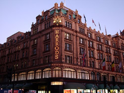 The lit-up Harrods store at dusk.